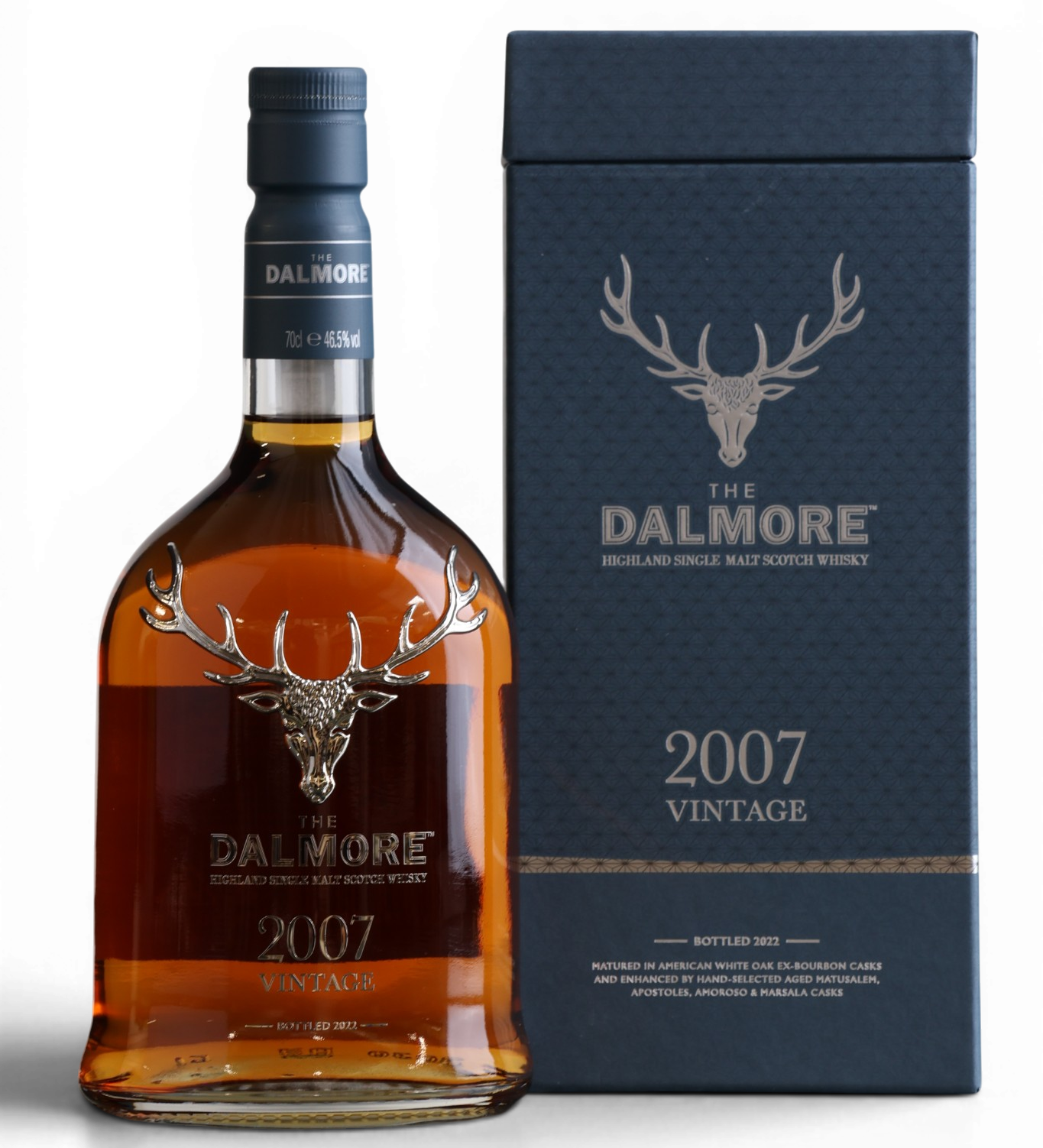 A bottle of Dalmore 2007 Vintage single malt whisky next to its dark navy blue presentation box, featuring the iconic stag logo on a clean white background.