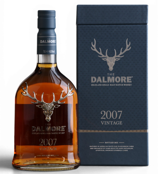 A bottle of Dalmore 2007 Vintage single malt whisky next to its dark navy blue presentation box, featuring the iconic stag logo on a clean white background.