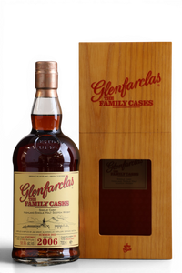 A bottle of Glenfarclas with the Family Casks 2006 single malt Scotch whisky next to its wooden presentation box, shown on a white background.