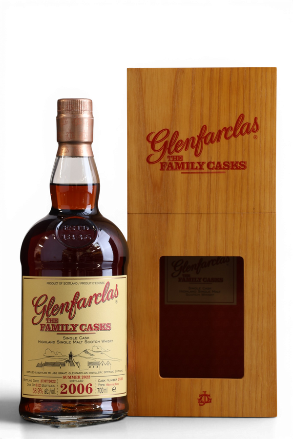 A bottle of Glenfarclas with the Family Casks 2006 single malt Scotch whisky next to its wooden presentation box, shown on a white background.