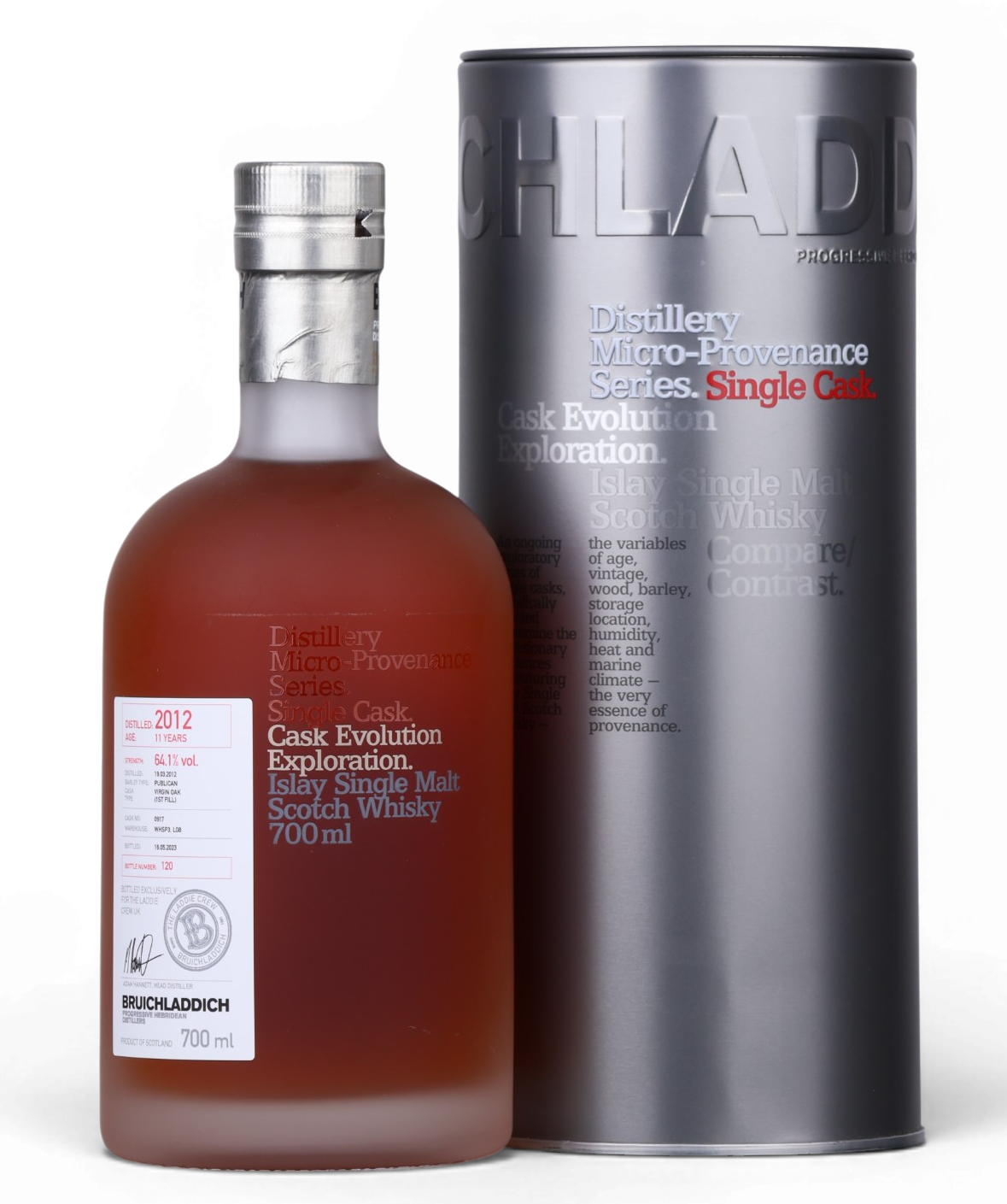A bottle of Bruchlanich Cask Evolution Exploration 2012 single malt Scotch whisky next to its tall metallic silver cylindrical packaging tube, photographed on a clean white background.